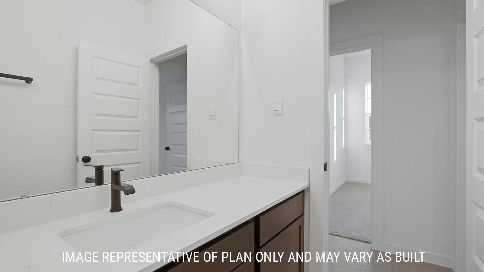 Newburgh secondary bathroom with vanity sink with white countertops and view of secondary bedroom.
