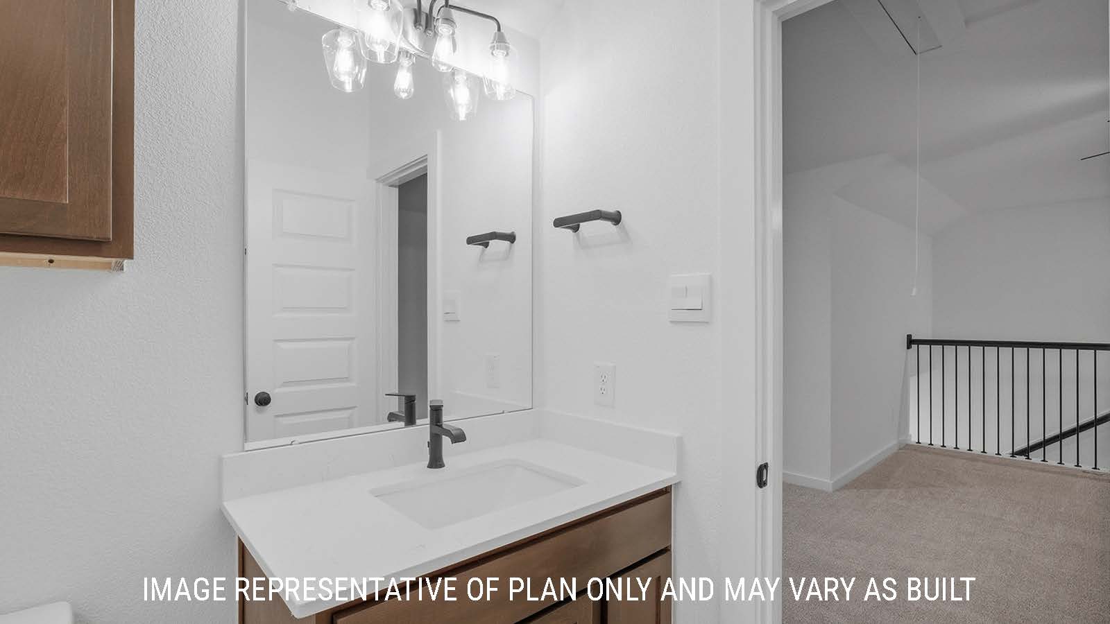 Newburgh secondary bathroom with vanity sink with white countertops and view of game room.
