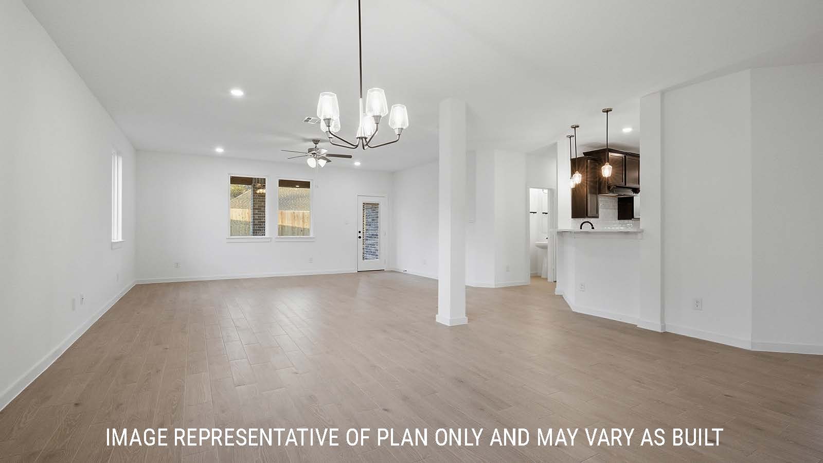 Newburgh dining room with view of kitchen and living room with windows for natural lighting.