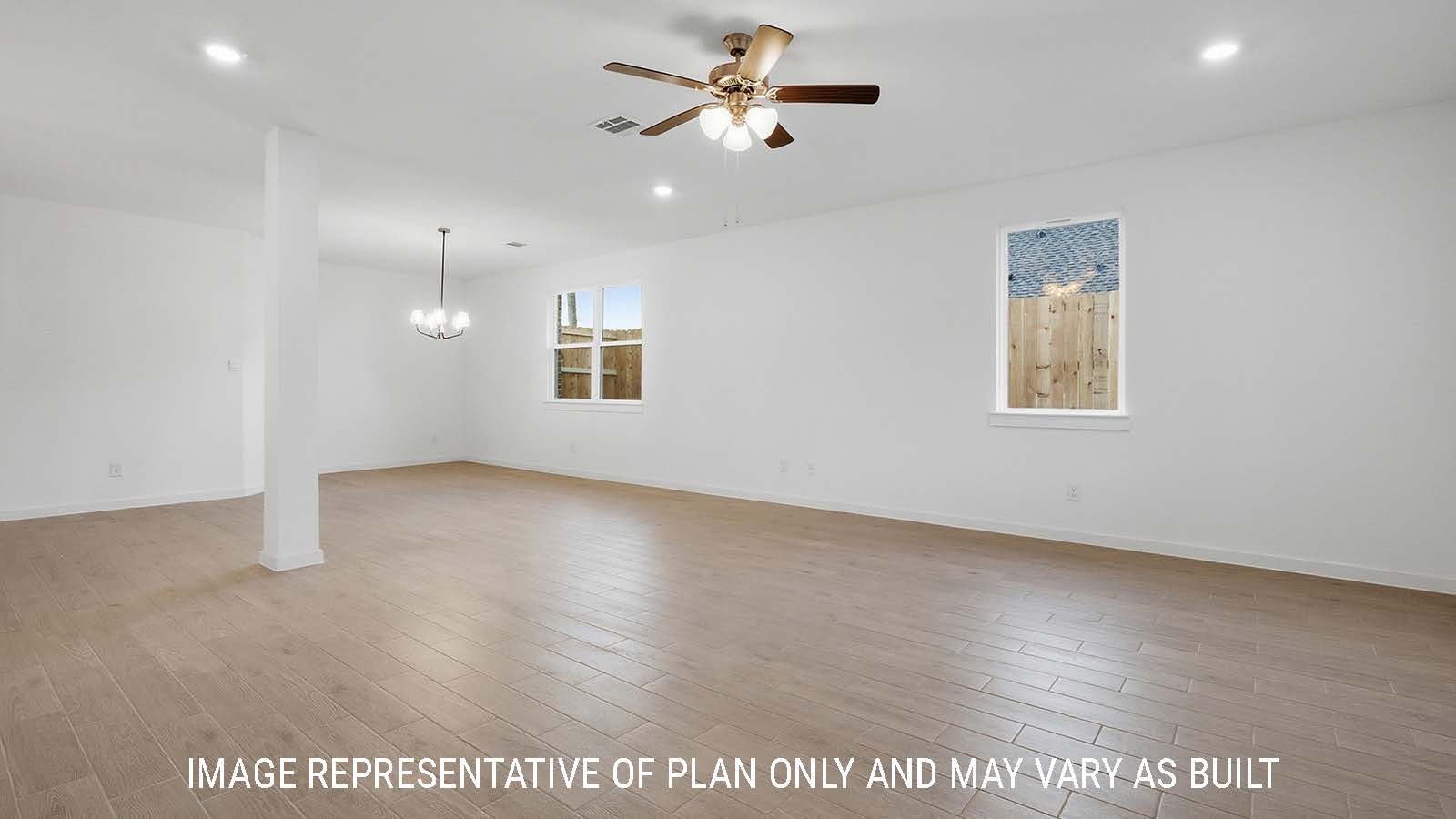 Newburgh dining room with vinyl plank flooring and windows for natural lighting and view of backyard.