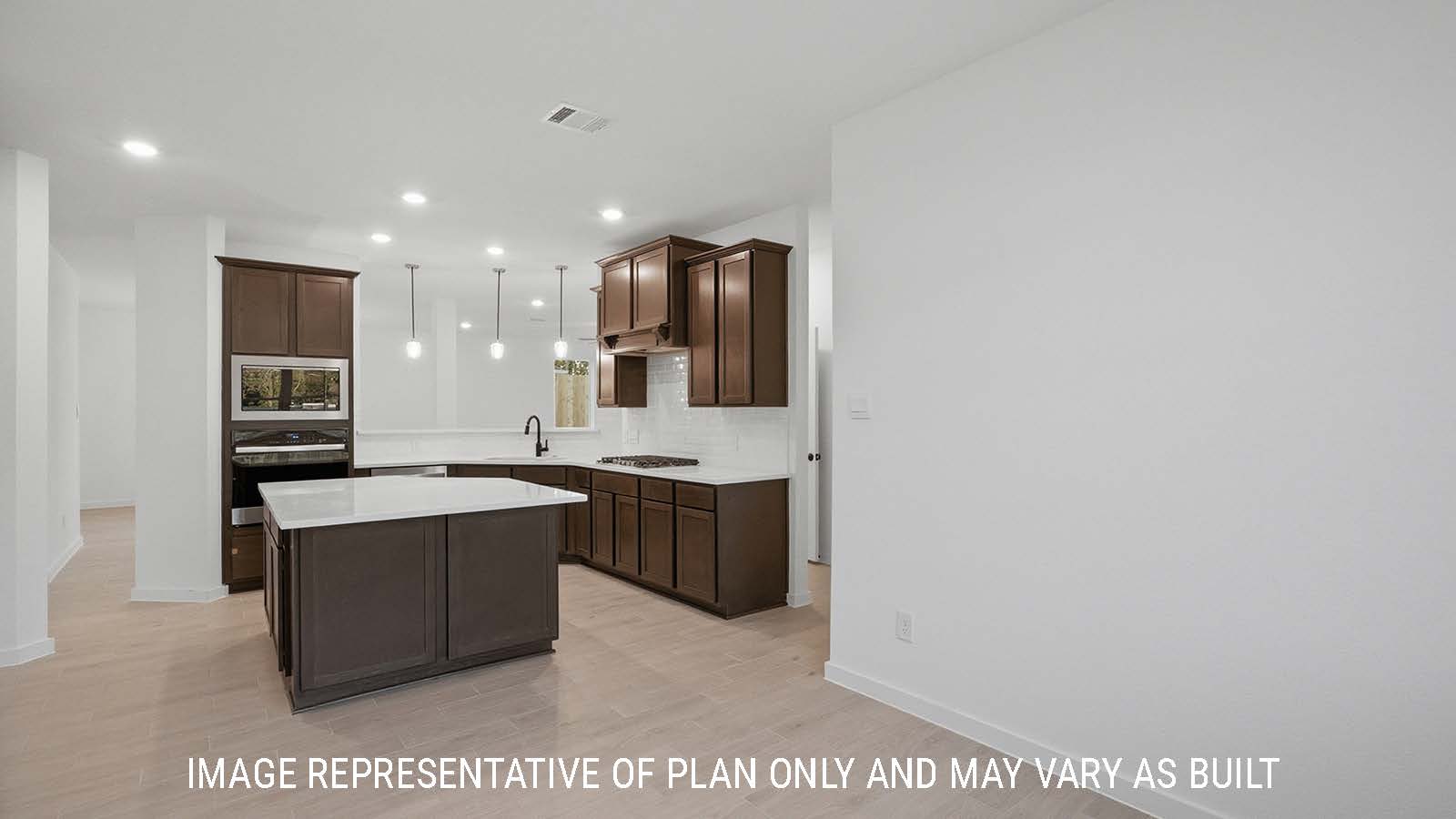 Newburgh kitchen with kitchen island and dark cabinets and white countertops and view of dining room.