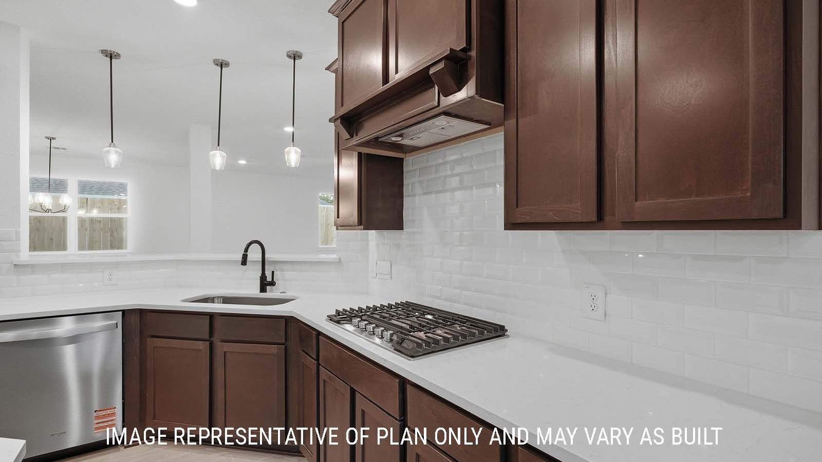 Newburgh kitchen with dark cabinets and white countertops and view of living room.