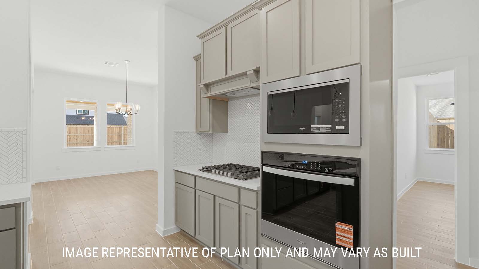 Waverley kitchen with grey cabinets with white countertops and view of living room.