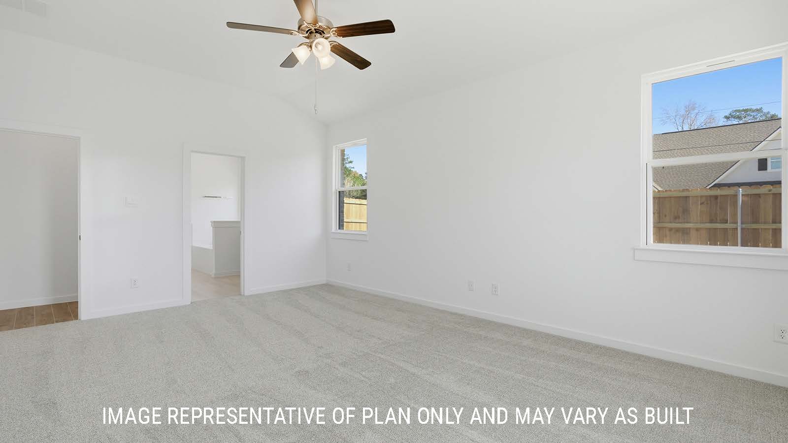 Waverley primary bedroom with carpeted flooring and view of primary bathroom.