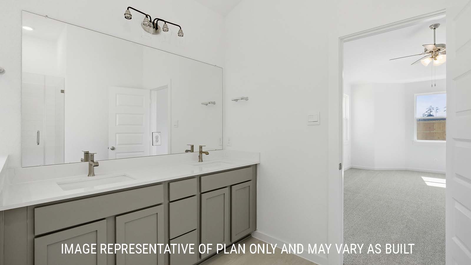 Waverley primary bathroom with double vanity sink with white countertops and view of primary bedroom.