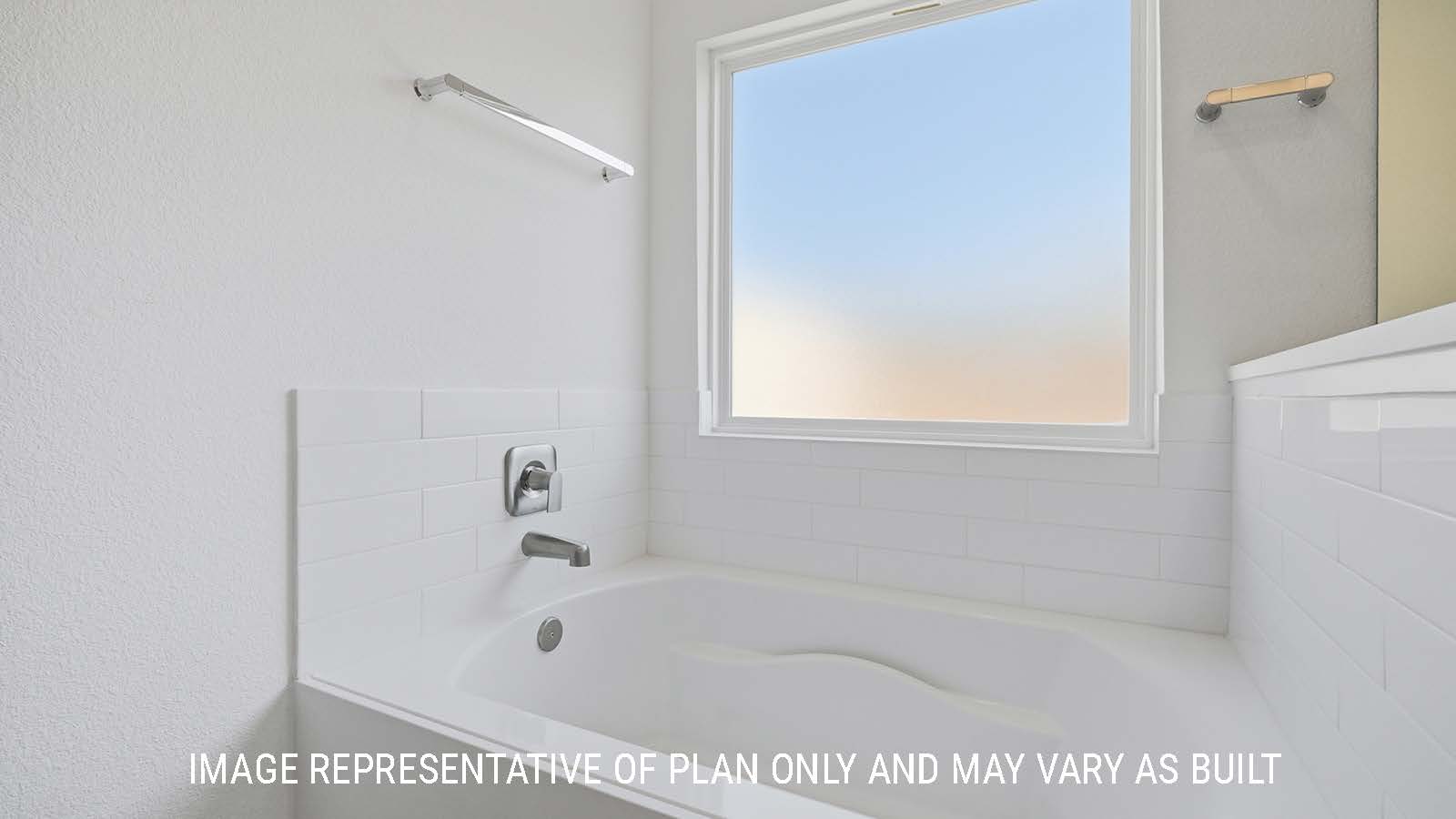 Waverley primary bathroom with garden tub and private window for natural lighting.