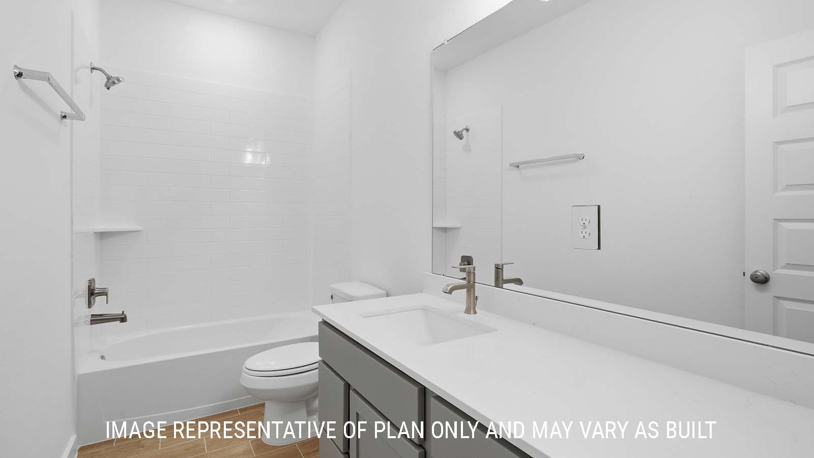 Waverley secondary bathroom with vanity sink with dark cabinets and shower and tub combo.