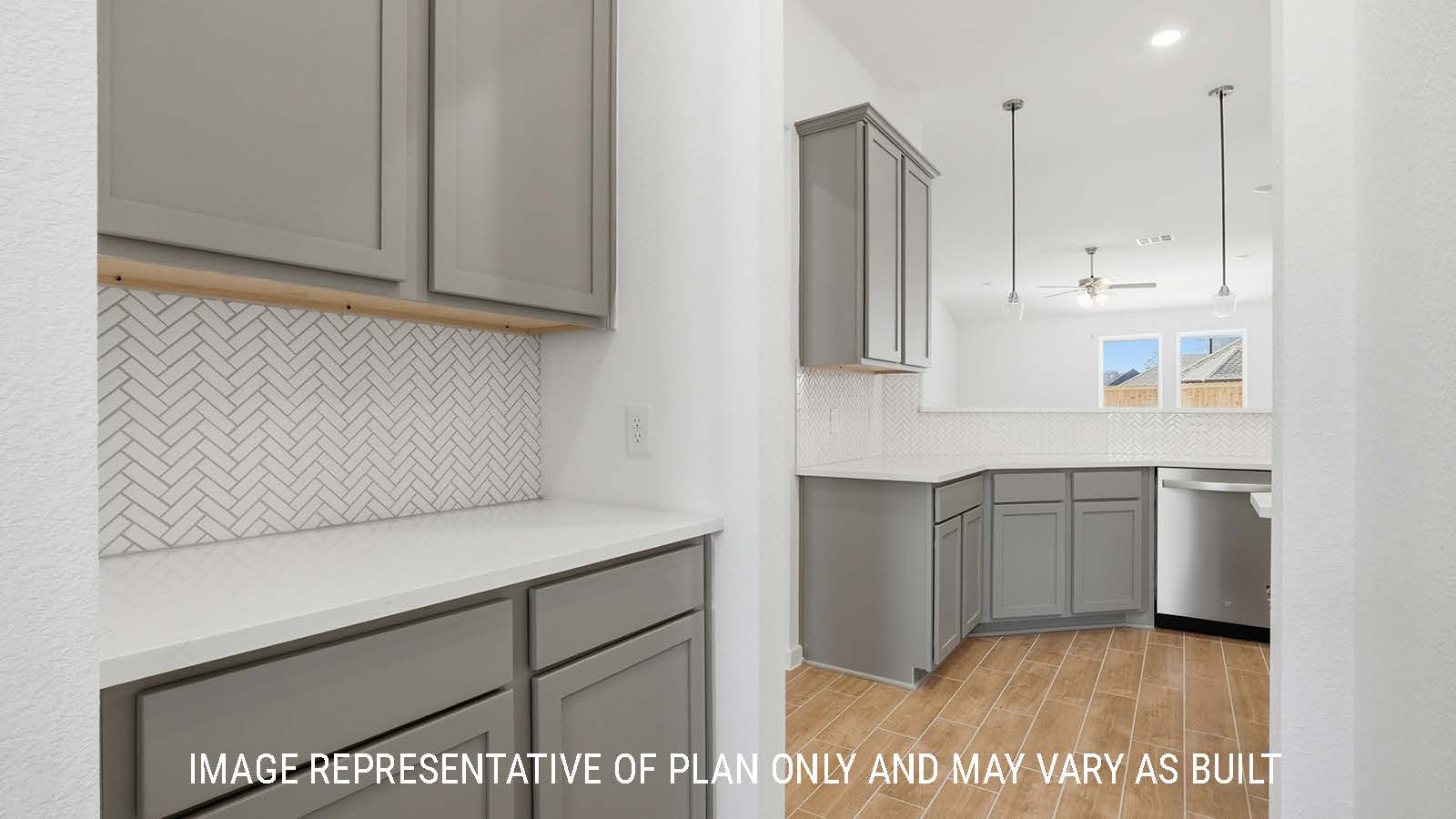Waverley utility room with dark cabinets and white countertops with view of kitchen.