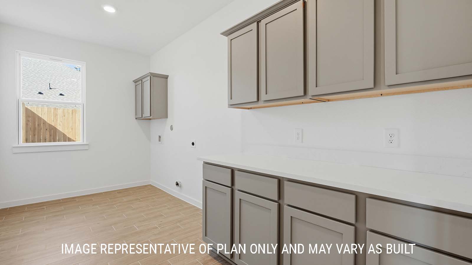 Waverley utility room with washer and dryer connections and window for natural lighting.
