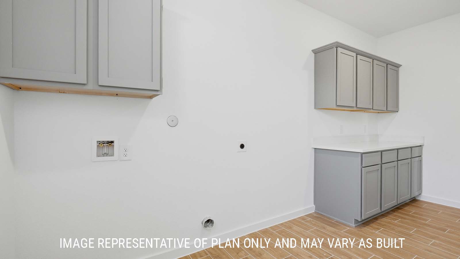 Waverley utility room with washer dryer connections and dark cabinets for storage.