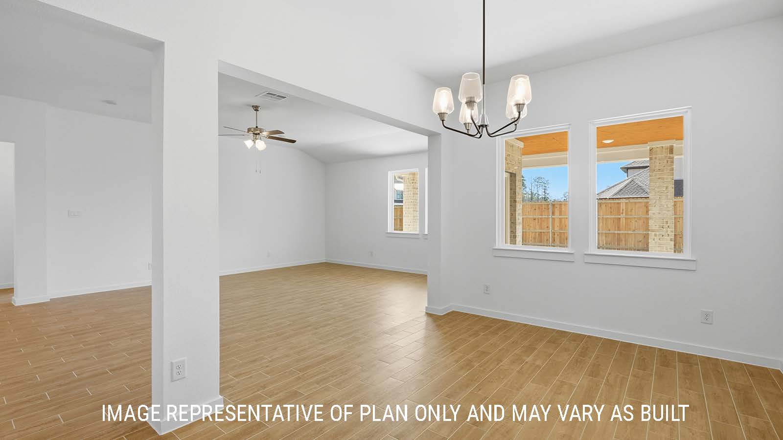 Waverley living room with windows for natural lighting and view of backyard.