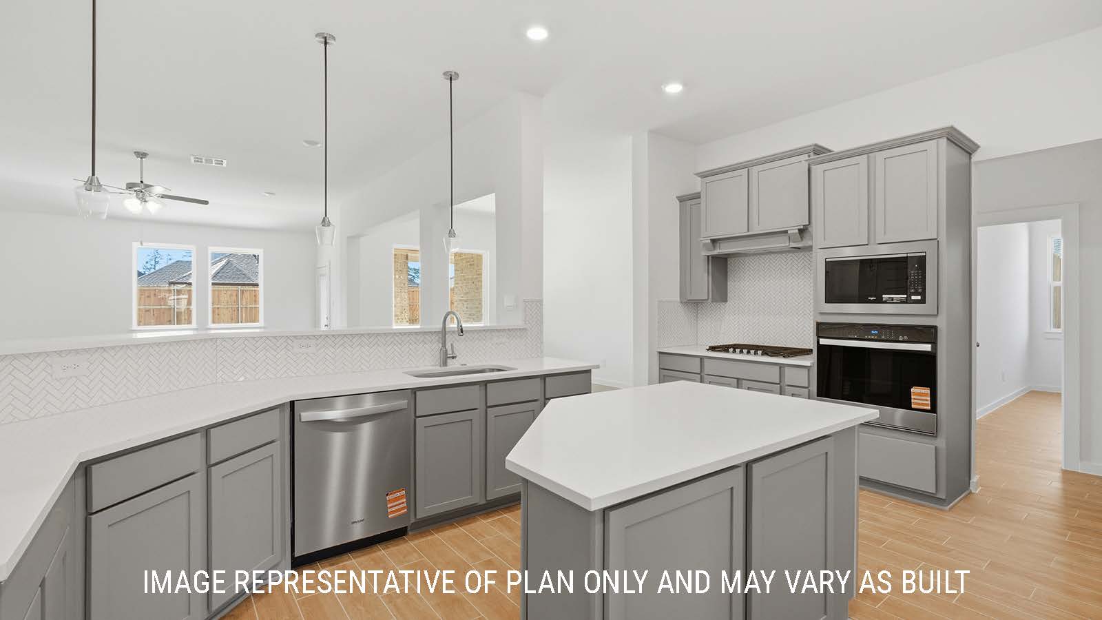 Waverley kitchen with kitchen island with grey cabinets and white countertops and view of living room.