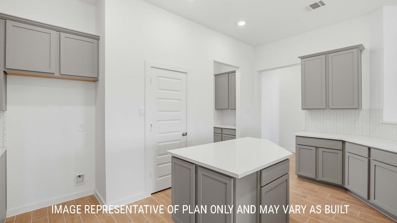 Waverley kitchen with kitchen island with grey cabinets and white countertops with view of dining room.