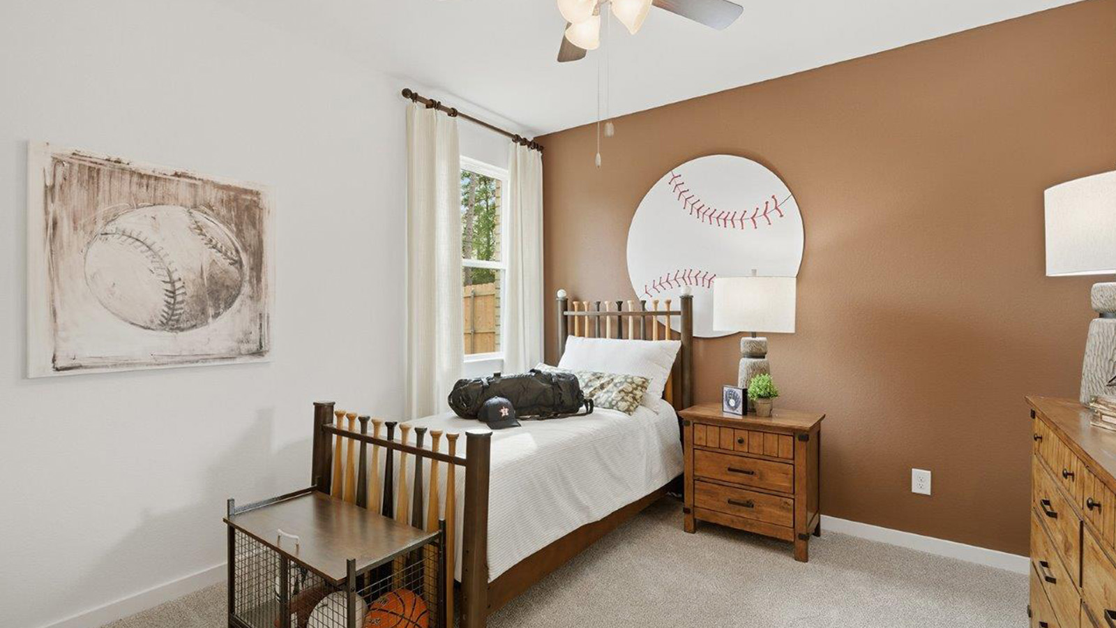The woods model home secondary bedroom with carpeted flooring and window for natural lighting.