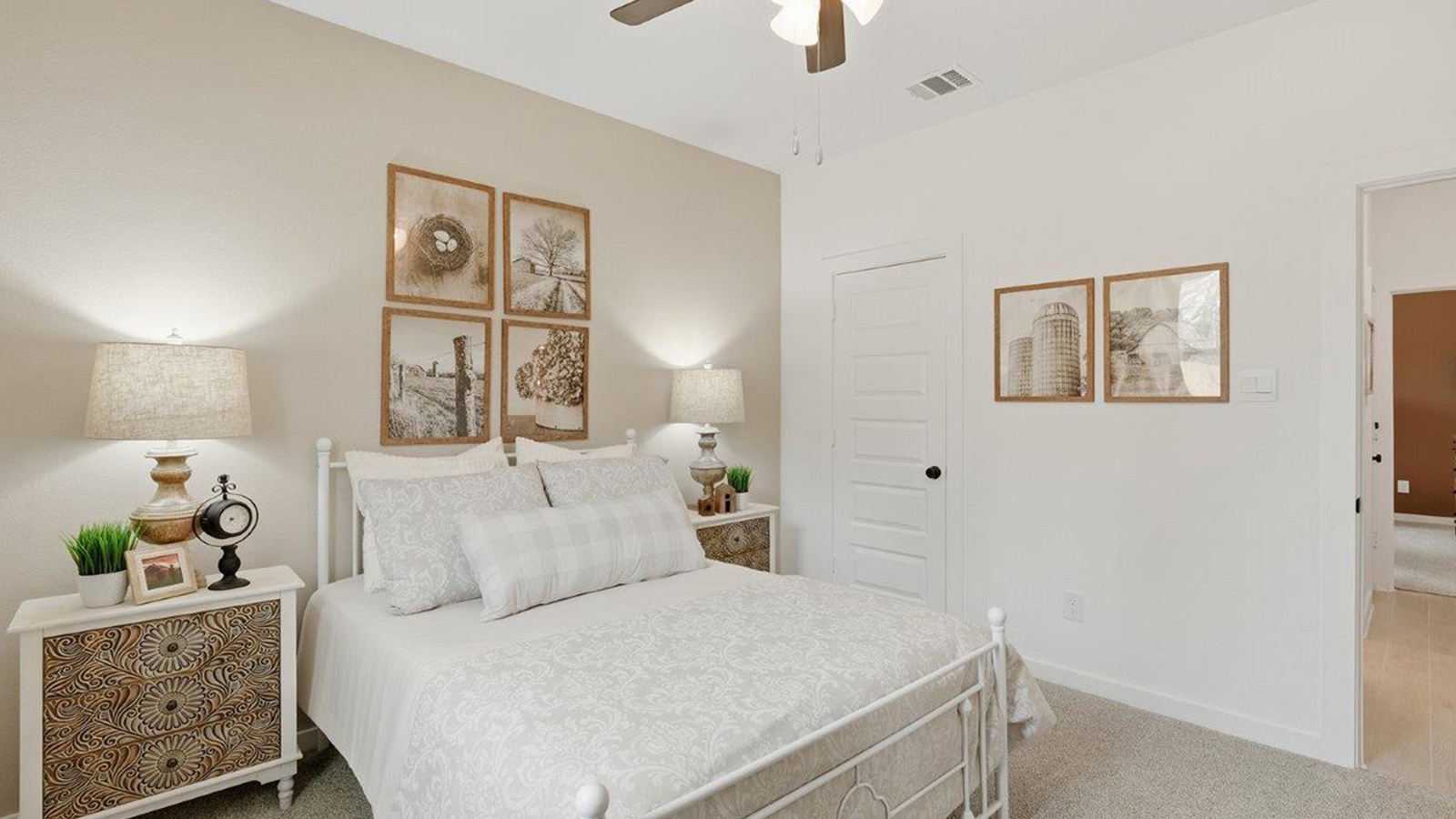 The woods model home secondary bedroom with carpeted flooring and window for natural lighting.