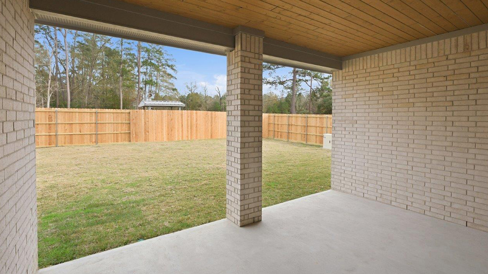 The woods model home berkshire back exterior with view of backyard.