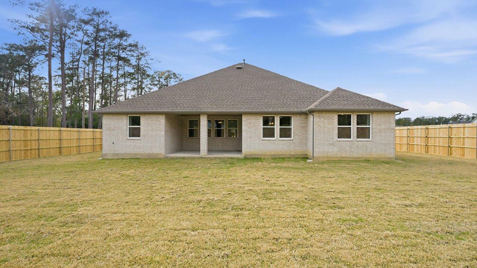 The woods model home berkshire back exterior with view of backyard.