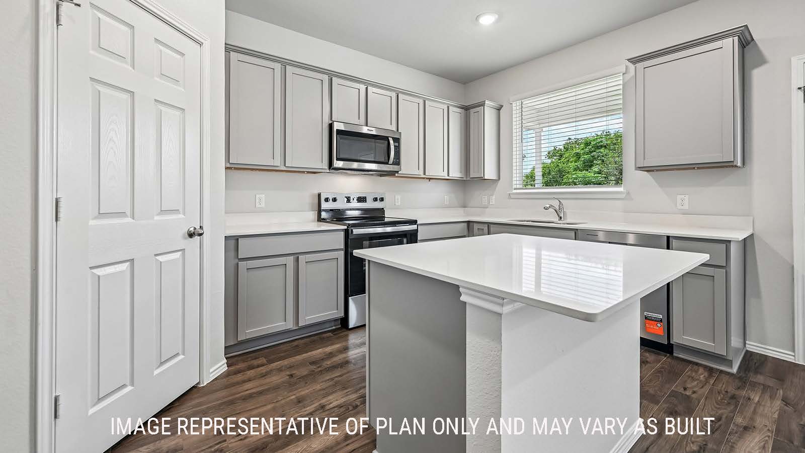 Madison kitchen with kitchen island and light cabinets with window for natural lighting.