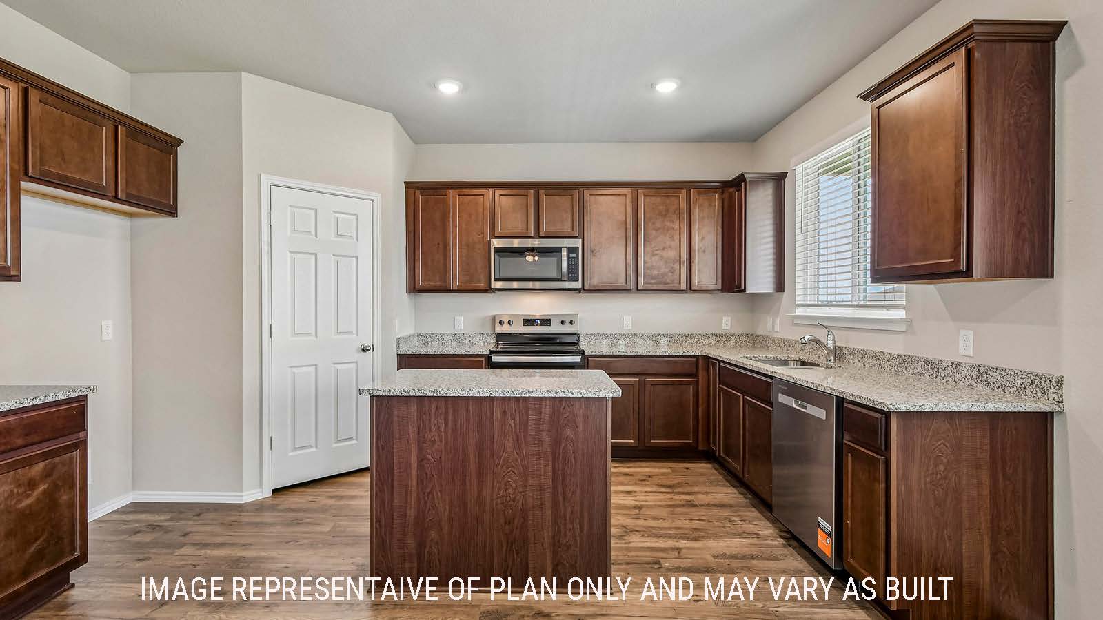 Prosper kitchen with kitchen island and dark cabinets with windows for natural lighting.