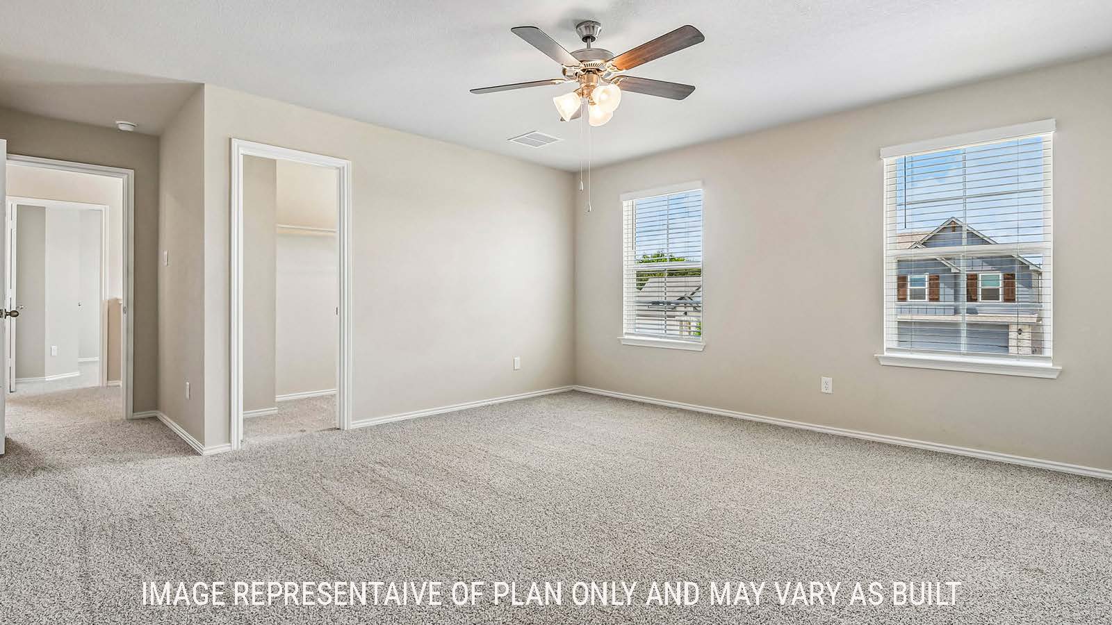 Prosper primary bedroom with carpeted flooring and windows for natural lighting.