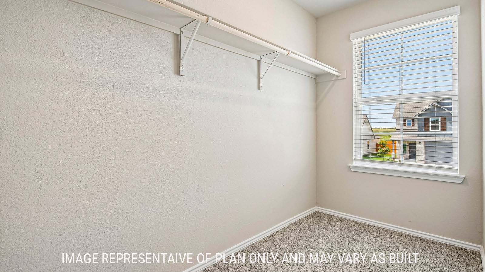 Prosper primary walk-in closet with carpeted flooring and shelving for storage.