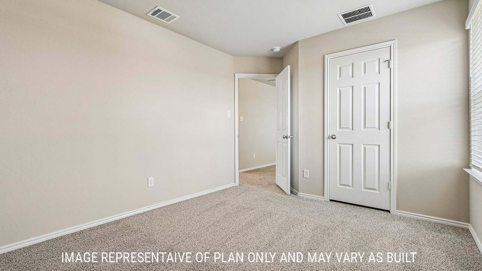 Prosper secondary bedroom with carpeted flooring and view of hallway.