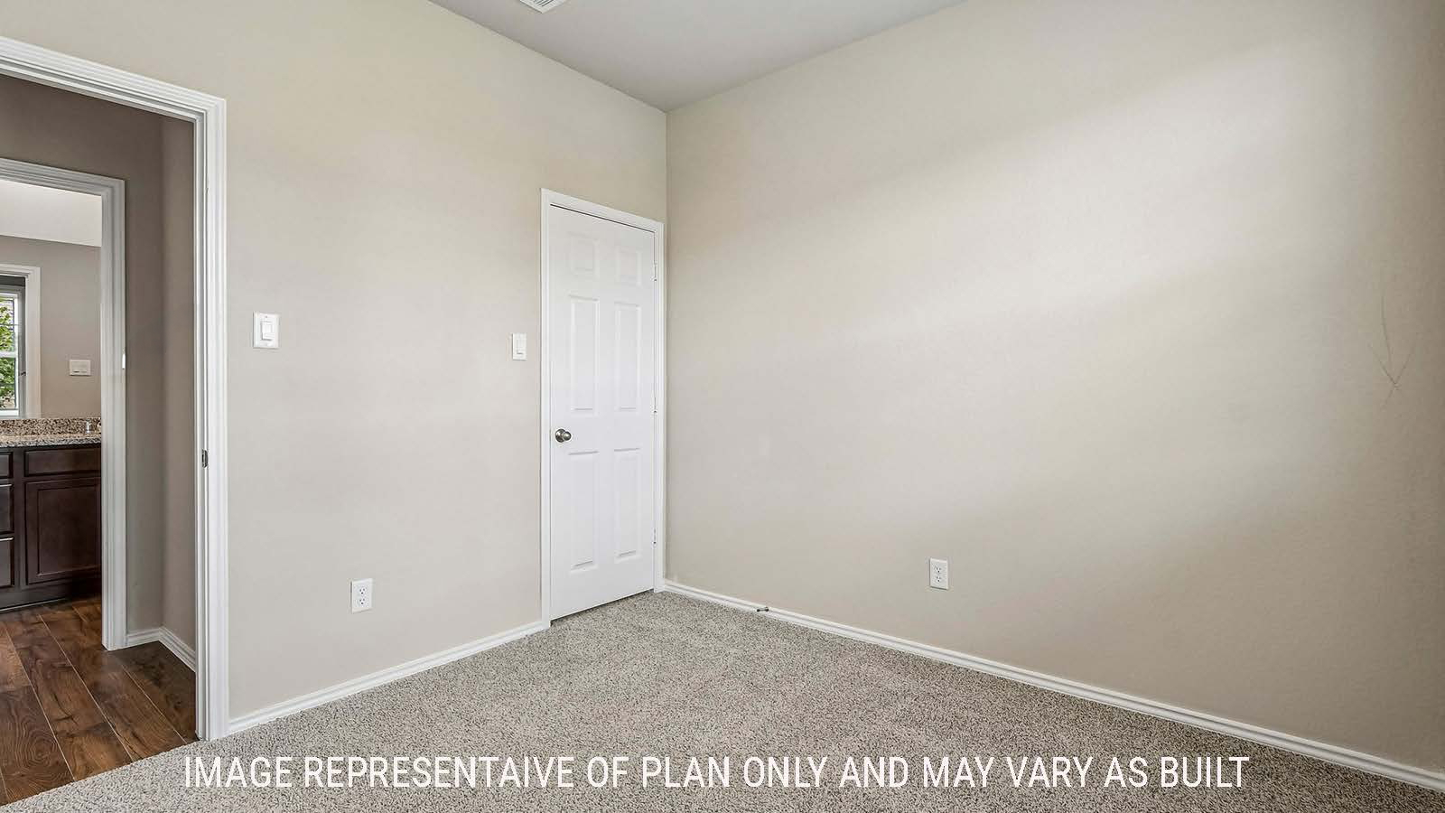 Prosper secondary bedroom with carpeted flooring and view of hallway.