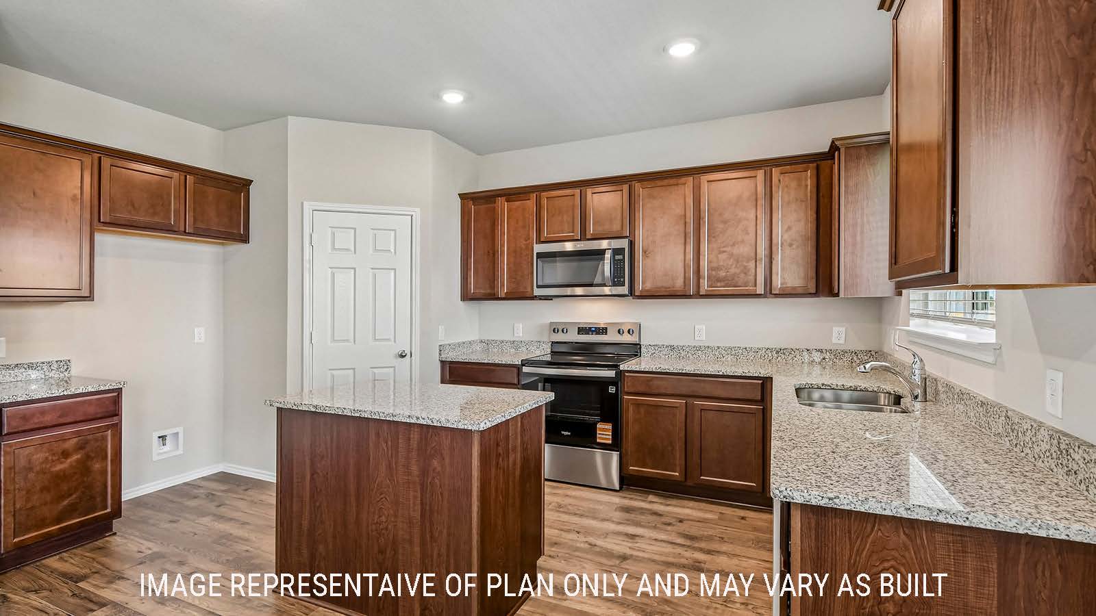 Prosper kitchen with kitchen island with dark cabinets and granite countertops.