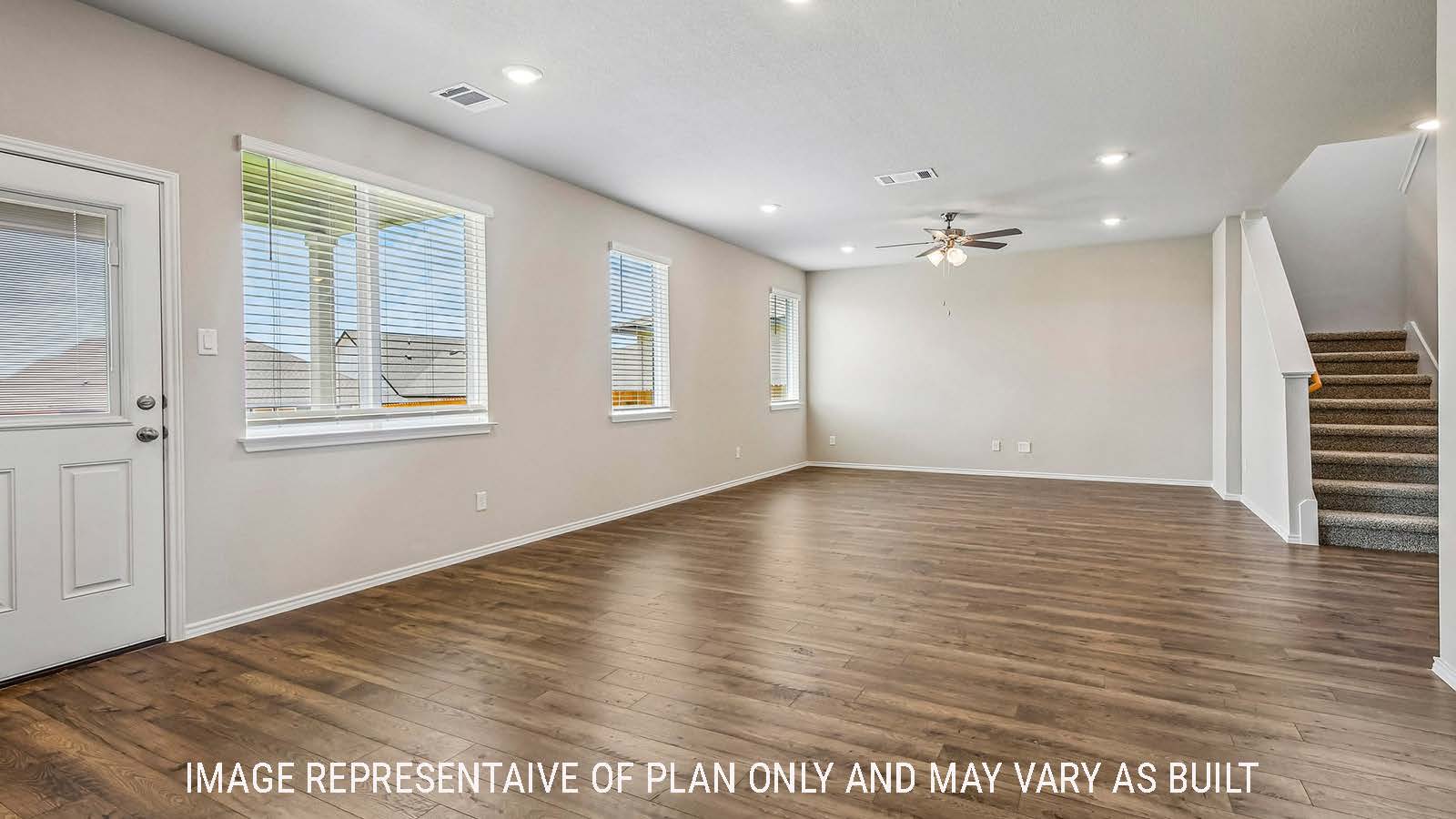 Prosper living room with view of open concept dining room and windows for natural lighting.