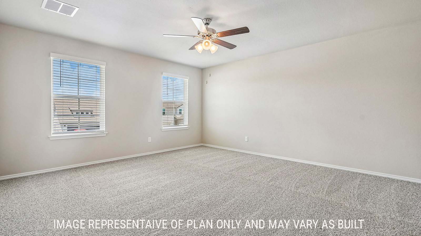Prosper primary bedroom with carpeted flooring and windows for natural lighting.