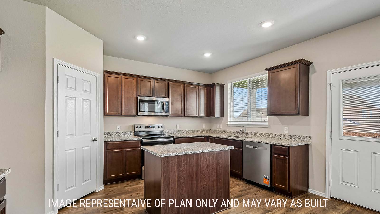 Prosper kitchen with kitchen island and dark cabinets with windows for natural lighting.