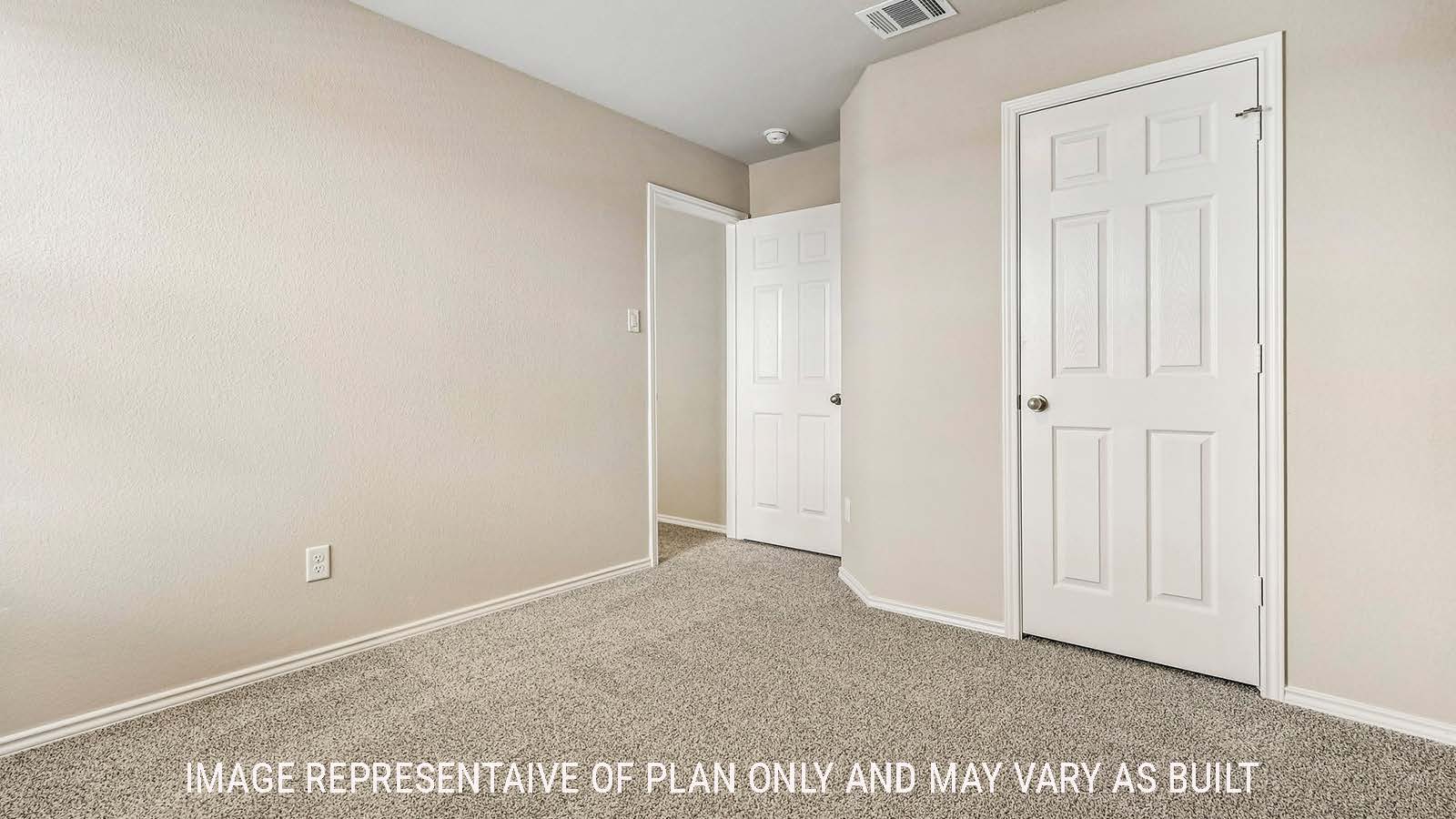 Prosper secondary bedroom with carpeted flooring and view of hallway.