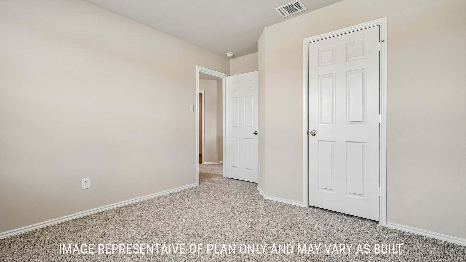 Prosper secondary bedroom with carpeted flooring and view of hallway.