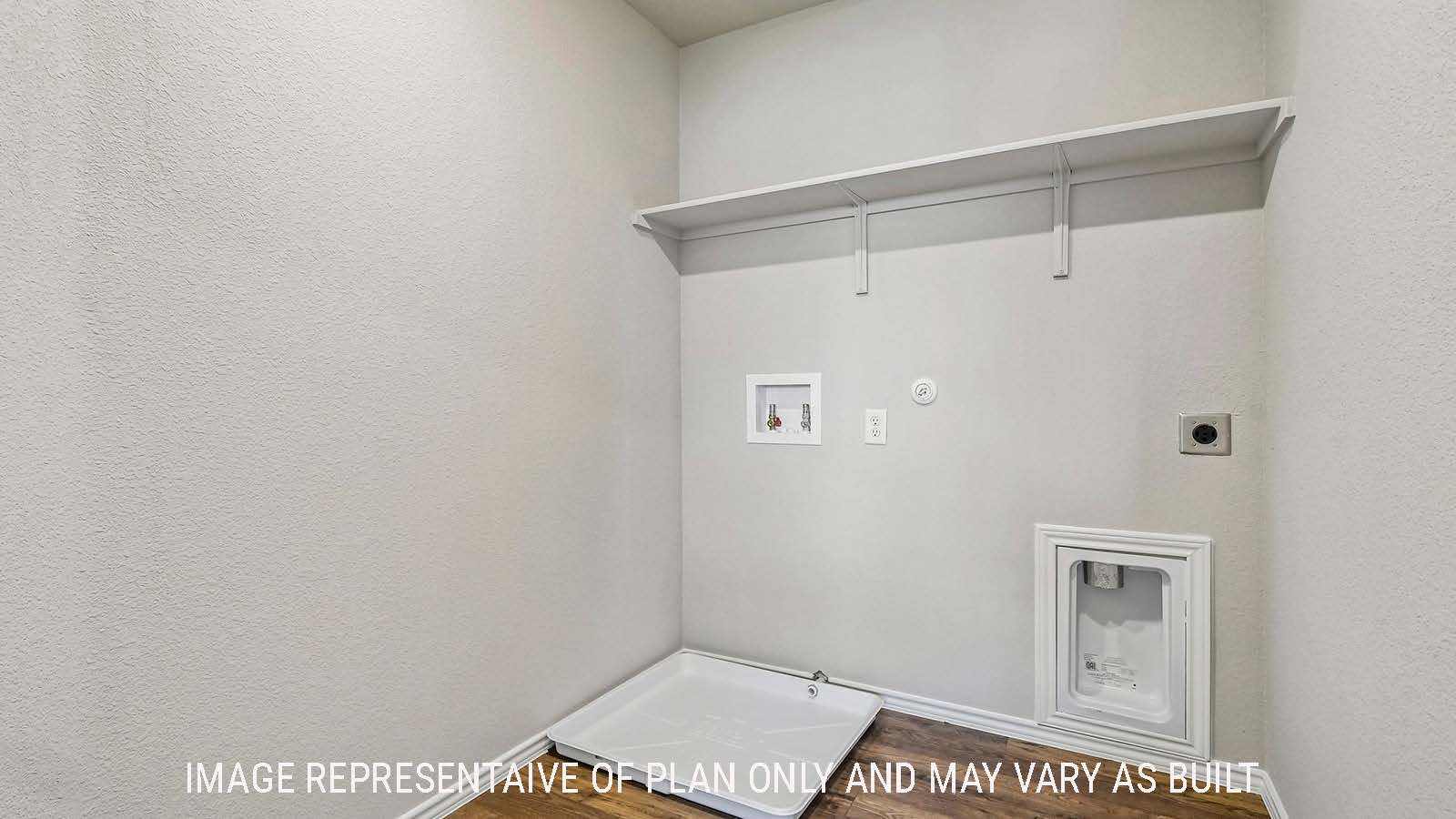 Prosper utility room with washer and dryer connections and shelving for storage.