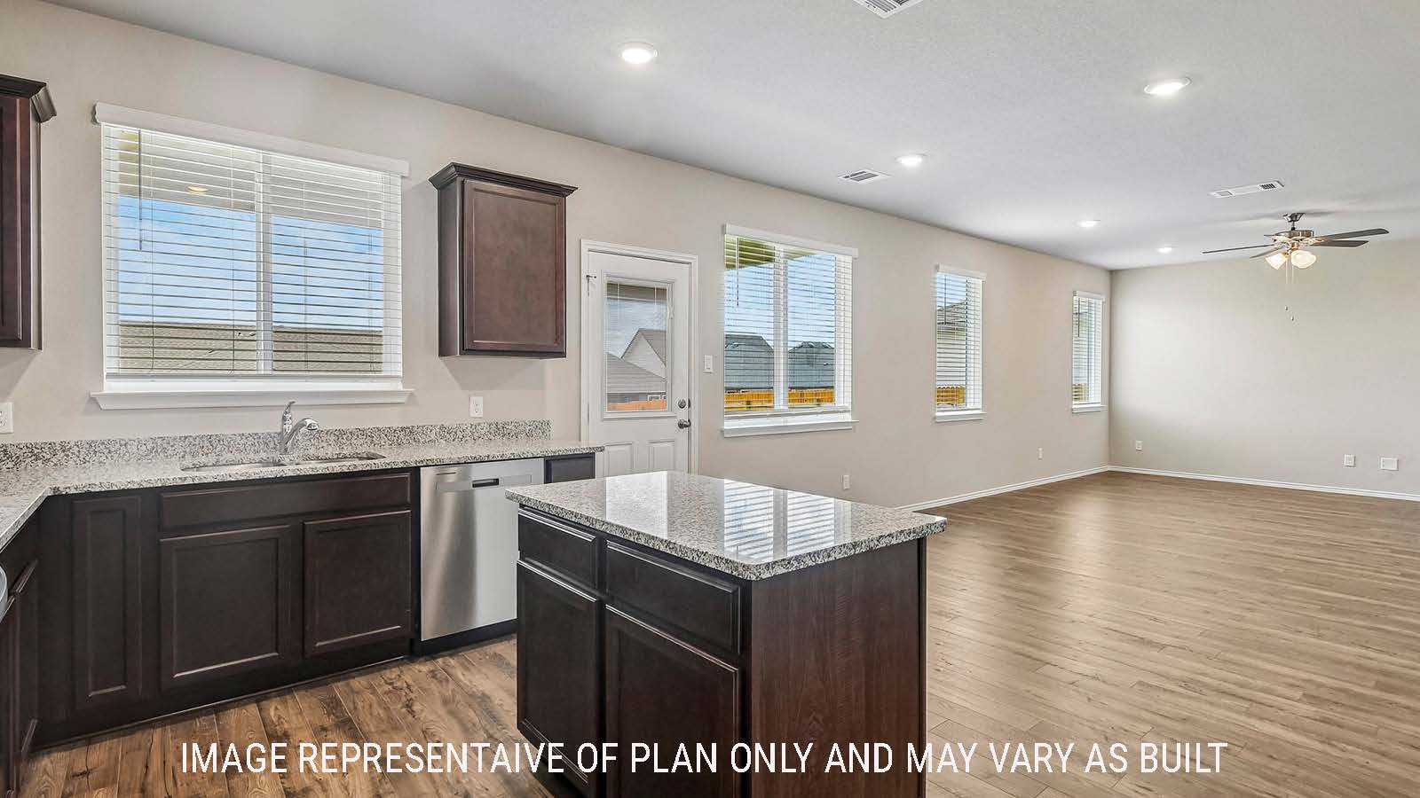 Prosper kitchen with kitchen island and dark cabinets with windows for natural lighting.
