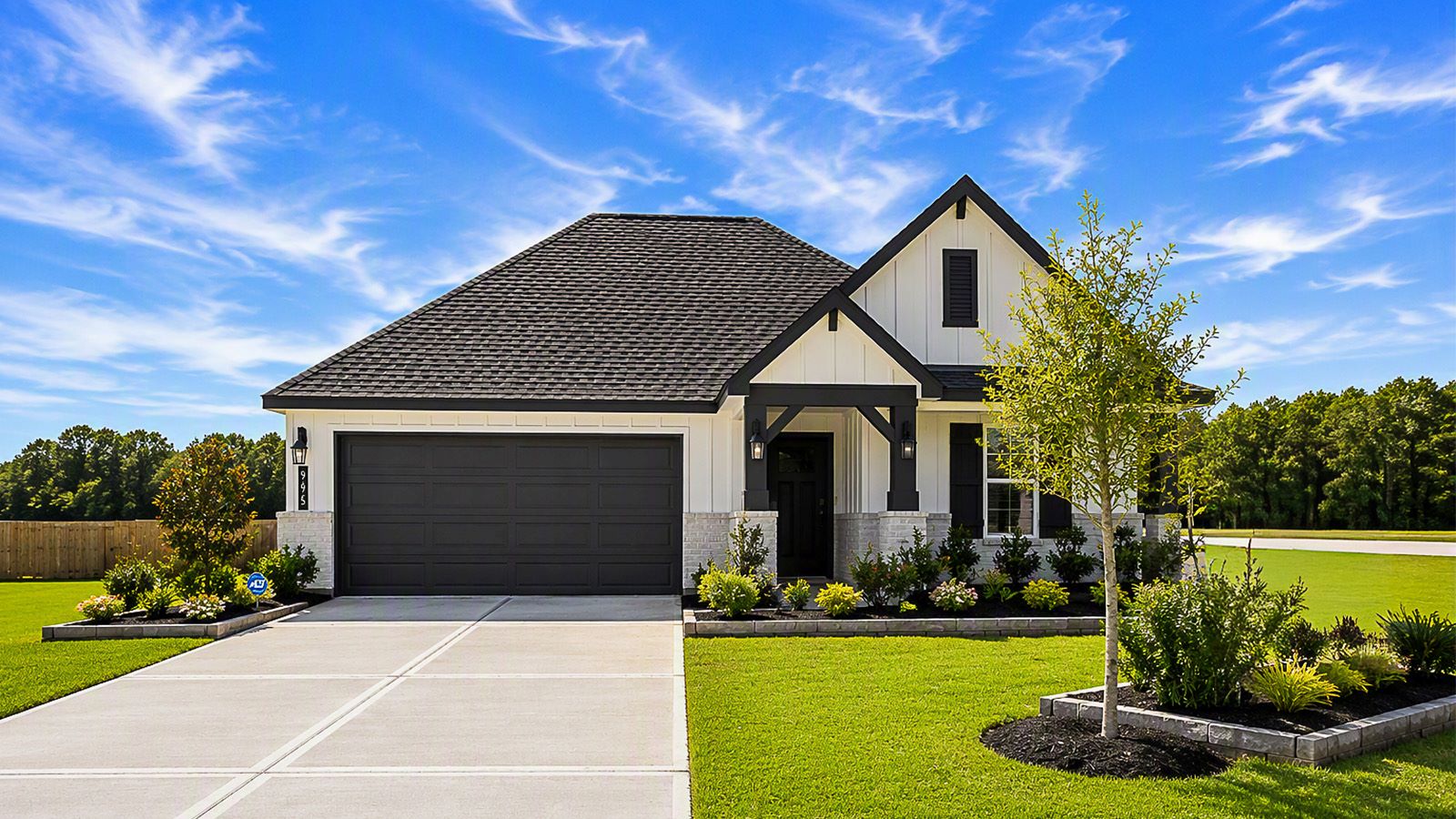 Highland Village model home front exterior with landscape.