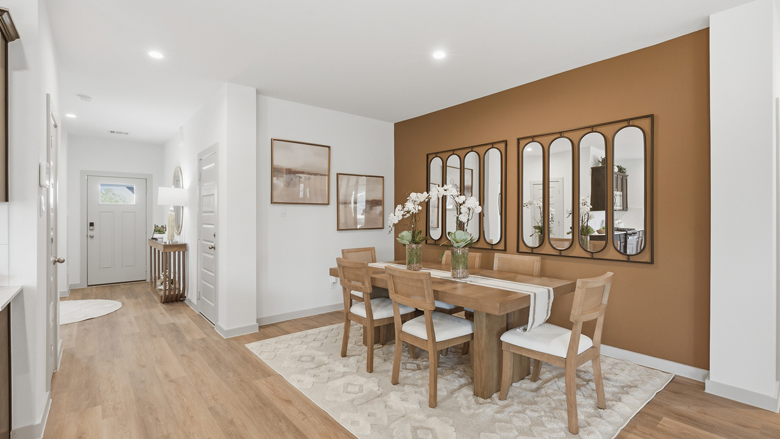 Highland Village model home dining room with view of front entry way hallway.