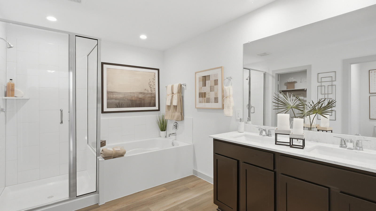 Highland Village model home primary bathroom with vanity sink and walk-in shower and garden tub.