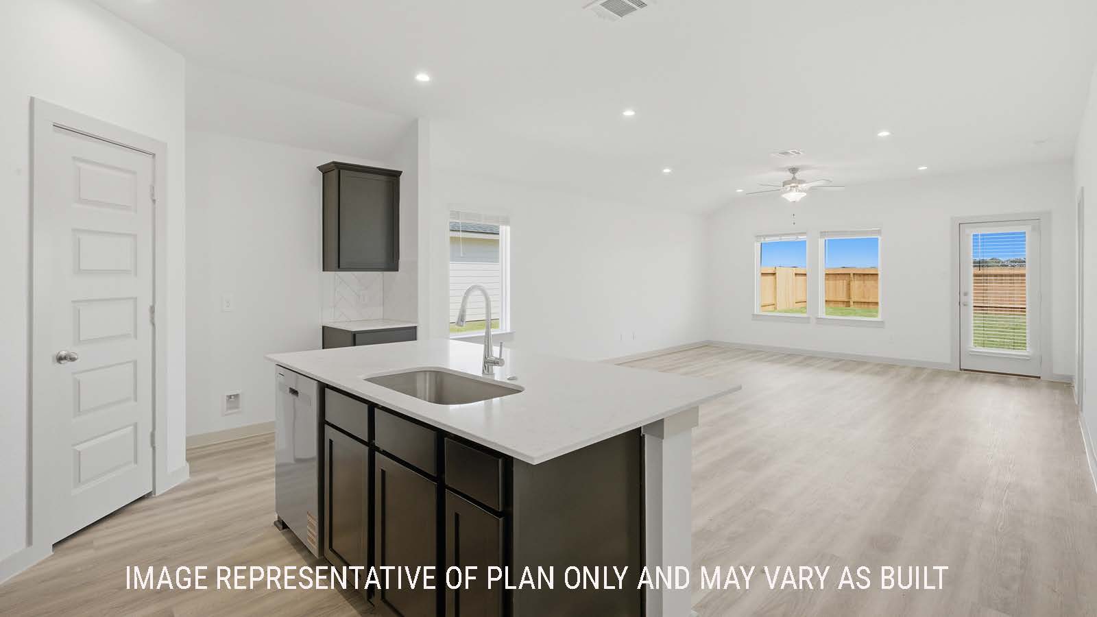 Elgin kitchen with kitchen island with granite countertops and view of open concept dining room and living room.