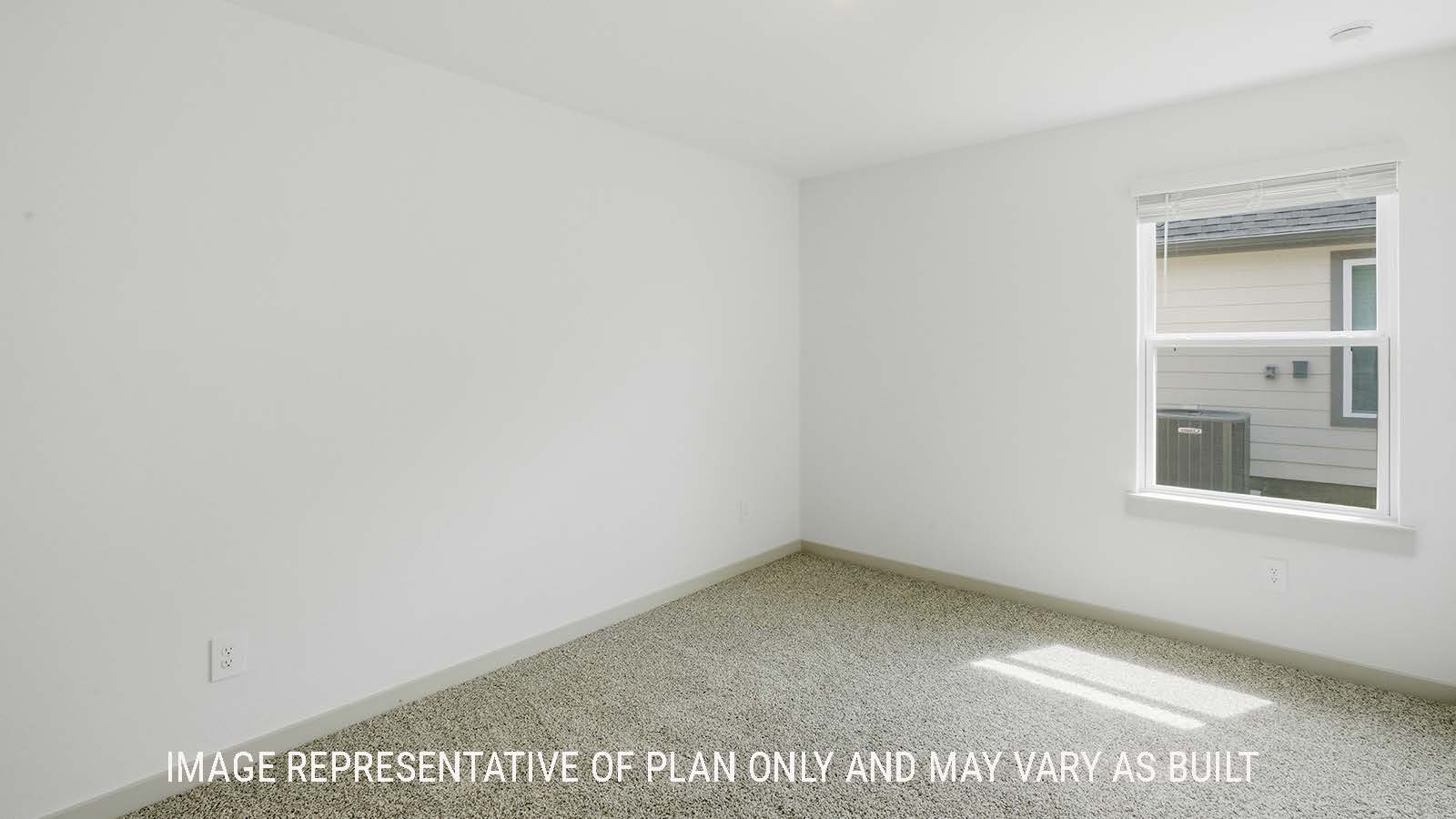 Elgin secondary bedroom with carpeted flooring and window for natural lighting.