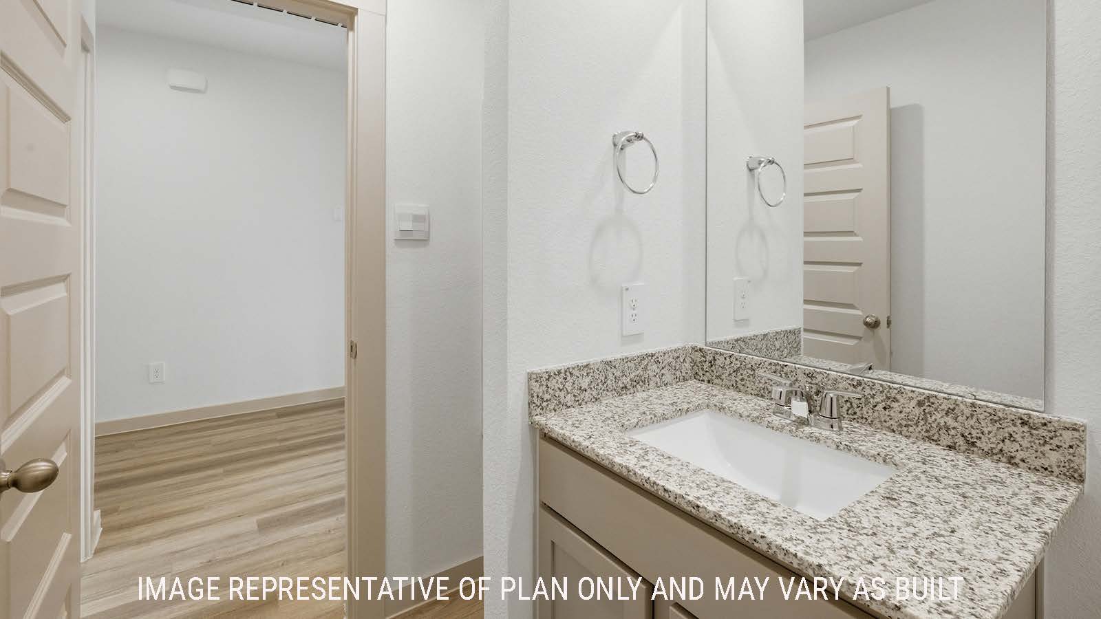 Texas Cali secondary bathroom with vanity sink and view of front entry hallway.