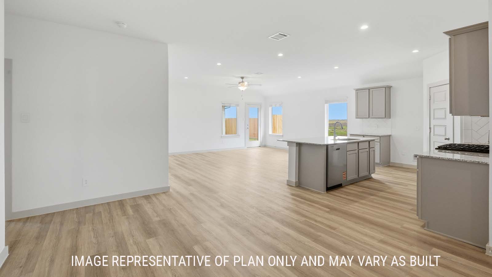 Lakeway dining room with vinyl plank flooring and view of open concept kitchen and living room.
