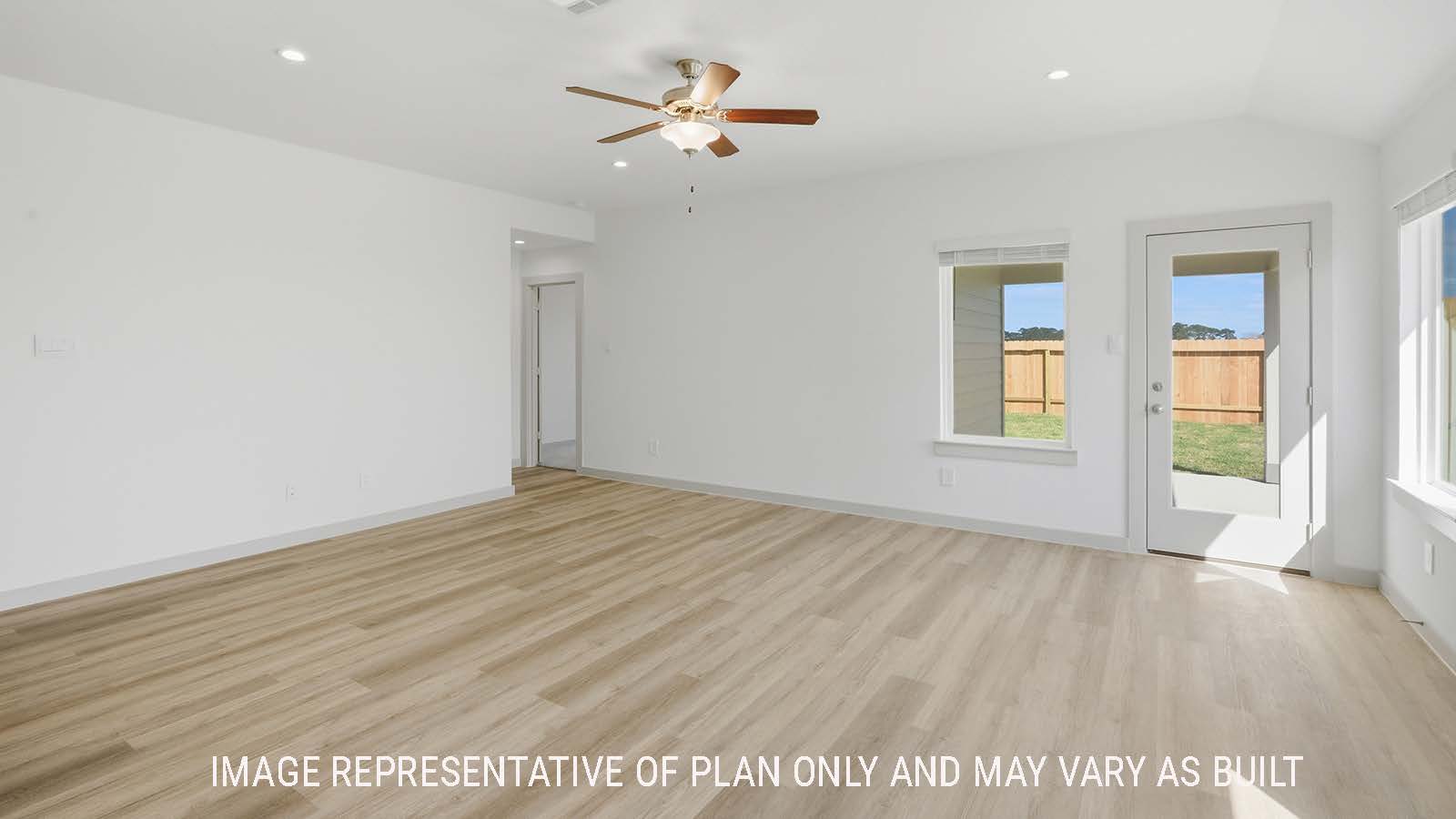 Lakeway living room with vinyl plank flooring with widows for natural lighting and view of back yard.