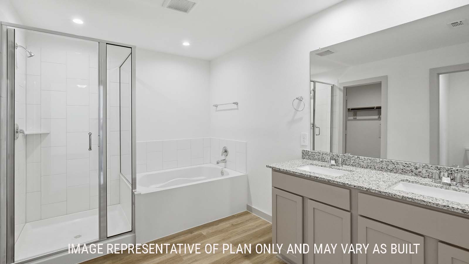 Lakeway primary bathroom with duel vanity sink with garden tub and walk-in shower.