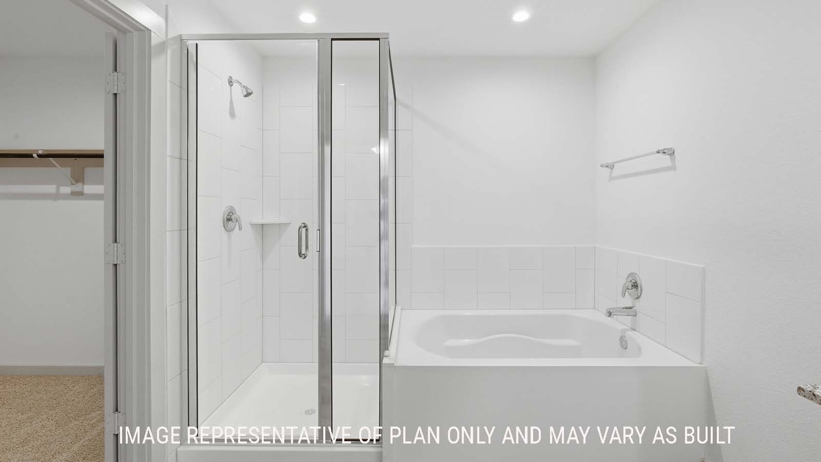 Lakeway primary bathroom with garden tub and walk-in shower with view of walk-in closet.