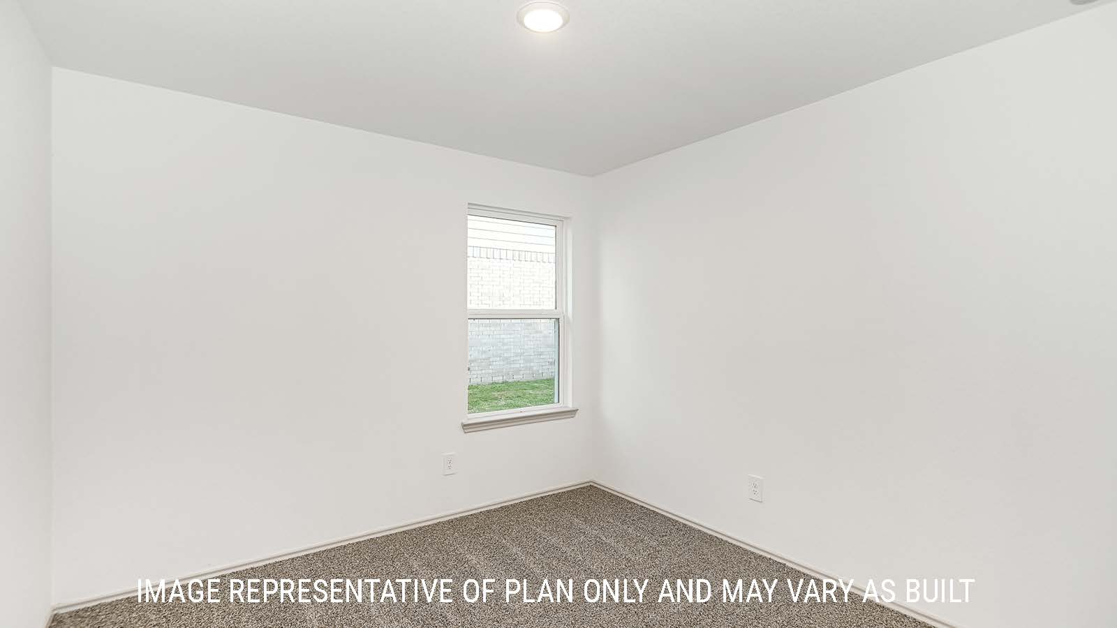 Lakeway secondary bedroom with carpeted flooring and window for natural lighting.