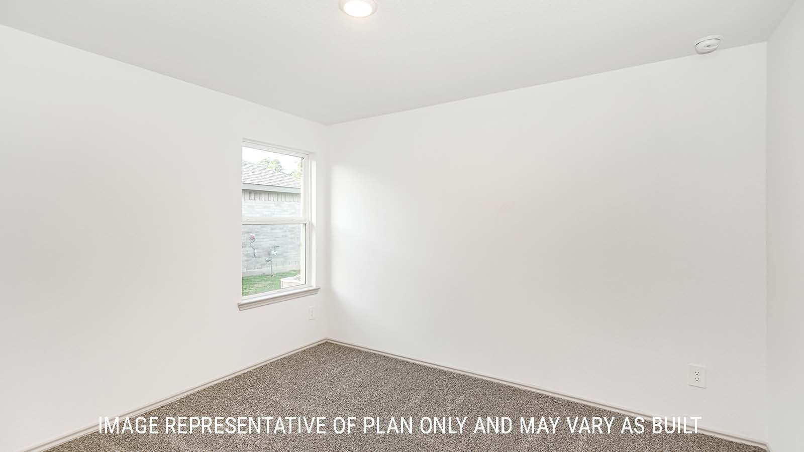 Lakeway secondary bedroom with carpeted flooring and window for natural lighting.