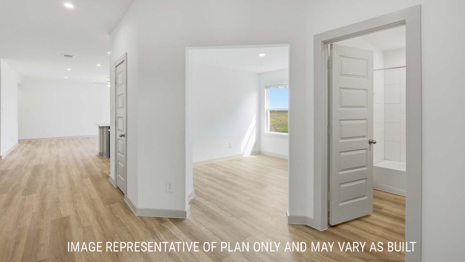 Lakeway front entry hallway with vinyl plank flooring and view of open concept kitchen.