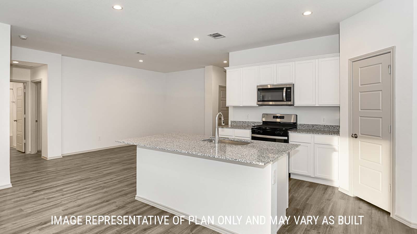 Lakeway kitchen with kitchen island and white cabinets with granite countertops.