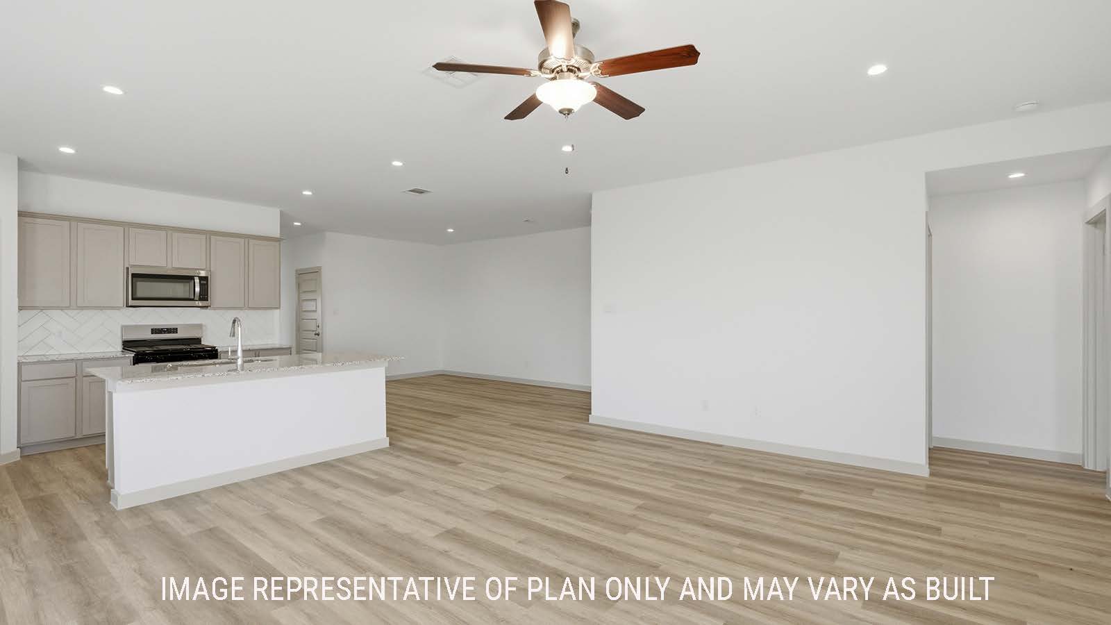Lakeway living room with vinyl plank flooring and view of open concept kitchen and dining room.